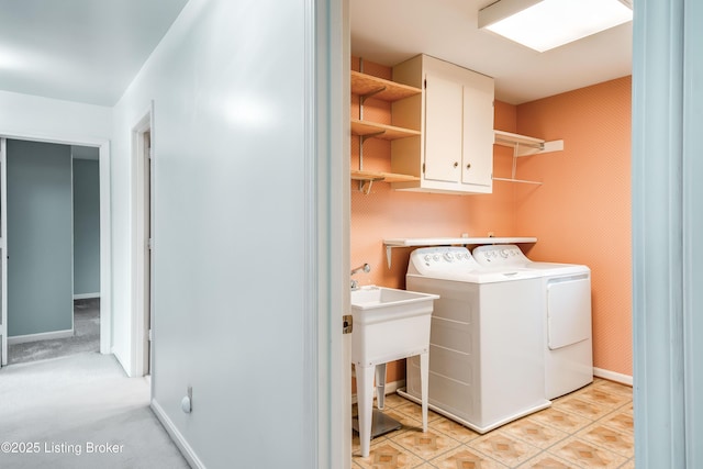 laundry area featuring cabinet space, washer and clothes dryer, and baseboards