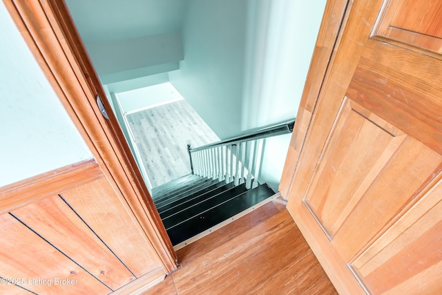 stairway with wood finished floors