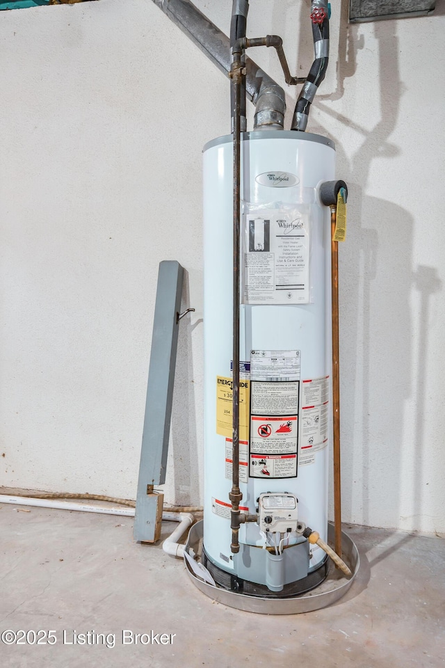 utility room featuring water heater