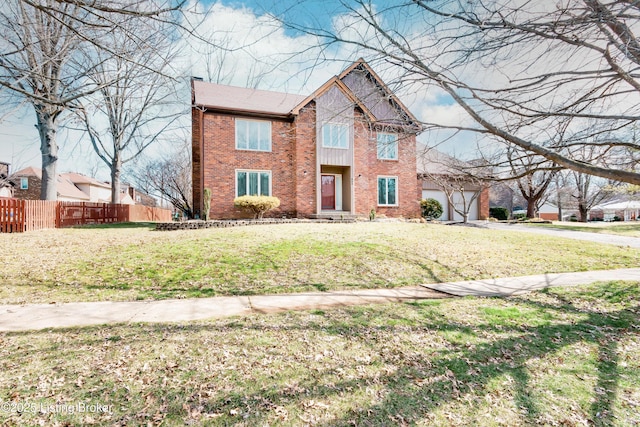 traditional home with a garage, brick siding, a front yard, and fence