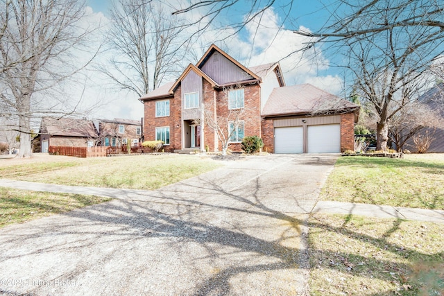 view of front of home featuring aphalt driveway, an attached garage, brick siding, and a front yard