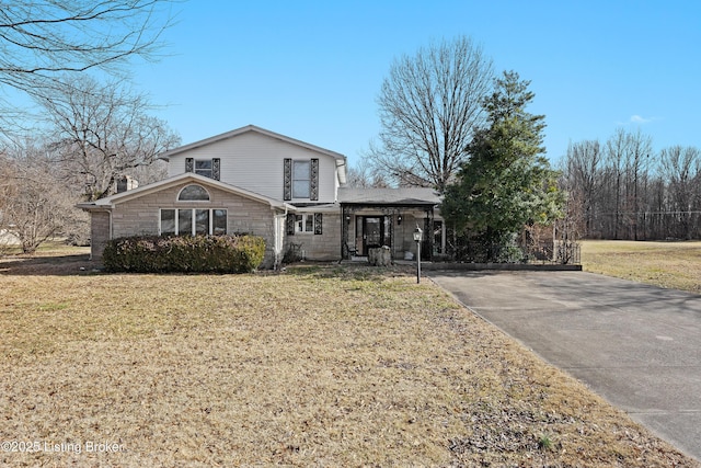 view of front facade with a front yard and stone siding