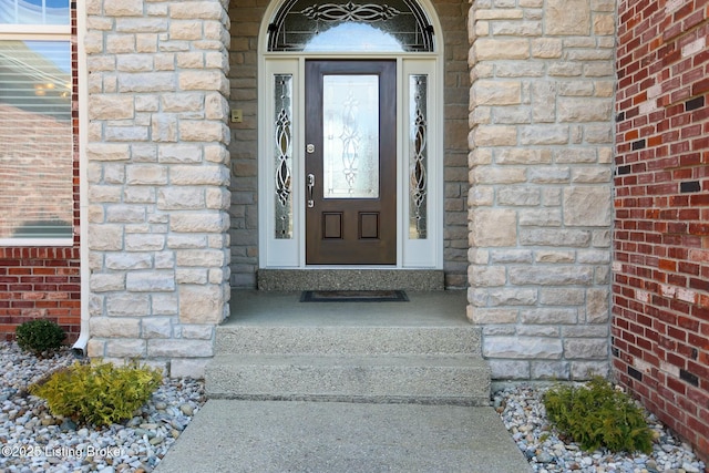 property entrance featuring stone siding and brick siding