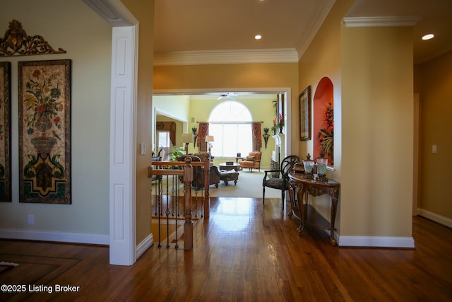 hall featuring baseboards, recessed lighting, wood finished floors, and crown molding