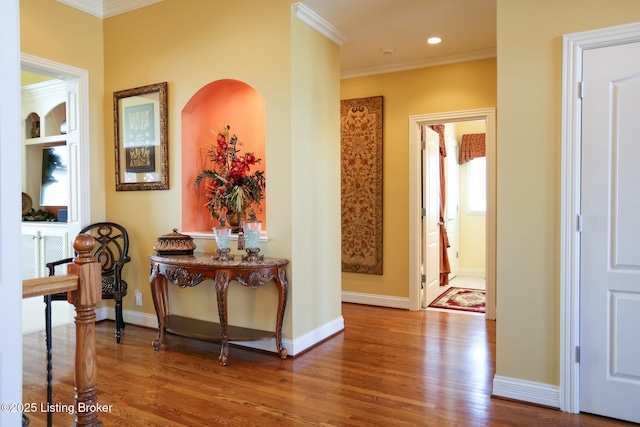 hall with ornamental molding, recessed lighting, wood finished floors, and baseboards