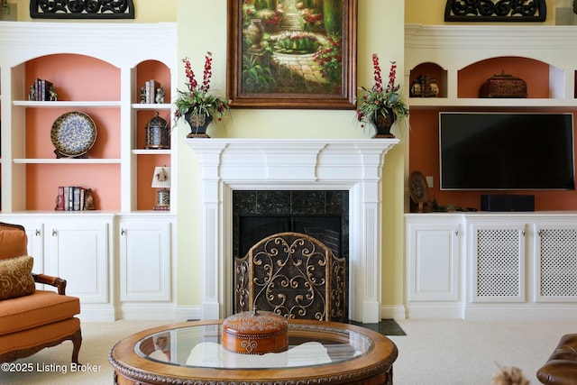 sitting room with carpet floors and a tiled fireplace