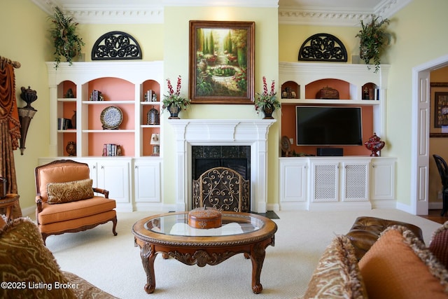 living area featuring built in shelves, carpet, a fireplace, and ornamental molding