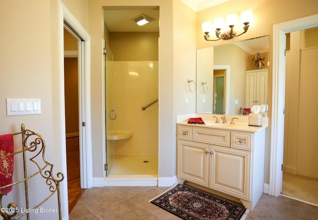 bathroom featuring a stall shower, tile patterned flooring, ornamental molding, and vanity