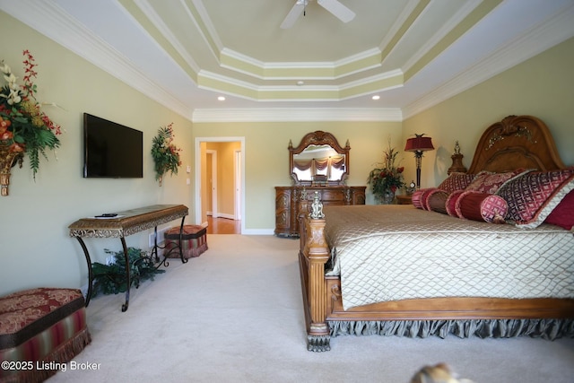 bedroom with a raised ceiling, carpet flooring, a ceiling fan, and crown molding