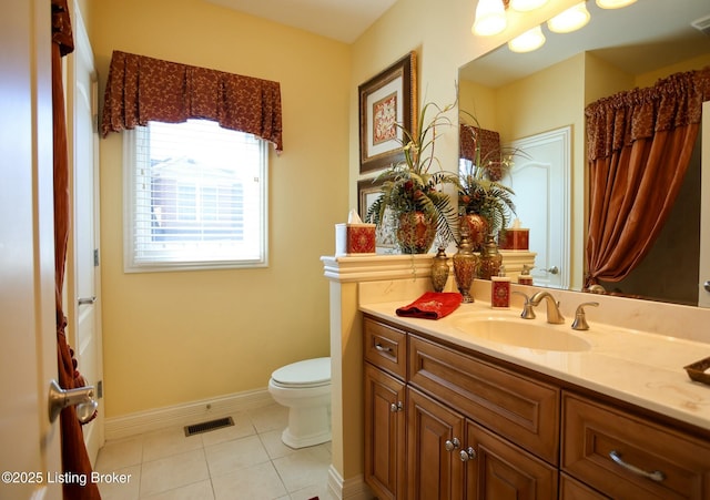 full bathroom featuring visible vents, toilet, vanity, baseboards, and tile patterned floors