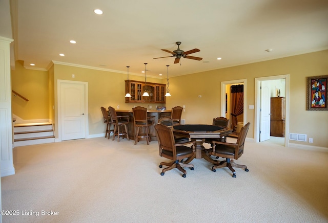 dining area featuring visible vents, light colored carpet, stairway, crown molding, and recessed lighting