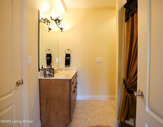 bathroom featuring baseboards, vanity, and tile patterned floors