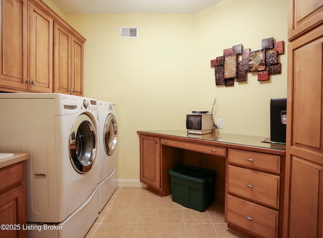 washroom with washing machine and dryer, visible vents, cabinet space, and light tile patterned floors