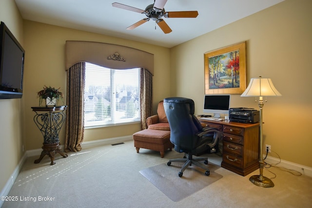 carpeted office featuring visible vents, baseboards, and ceiling fan