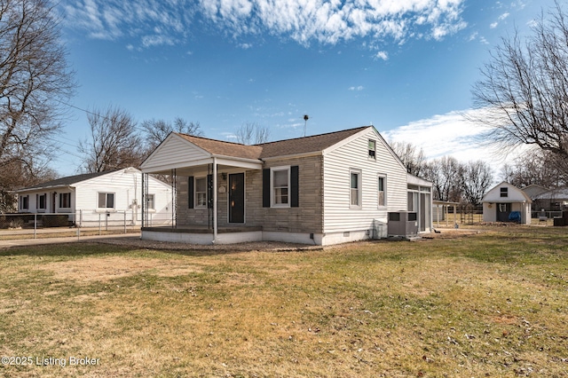 exterior space with covered porch, crawl space, a lawn, and fence