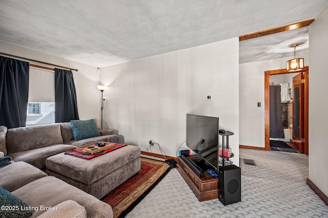 living area featuring carpet floors, visible vents, and baseboards