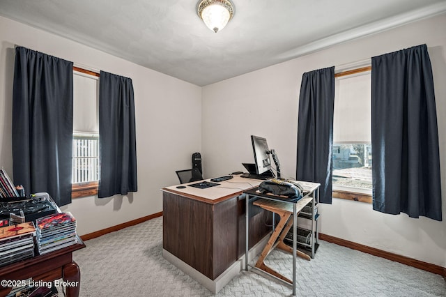 office space with light carpet and baseboards