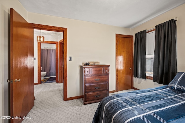 bedroom with light carpet and baseboards