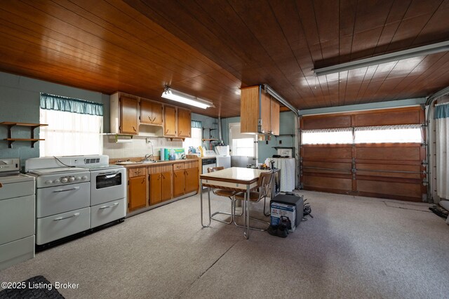 kitchen featuring open shelves, washing machine and clothes dryer, and wood ceiling