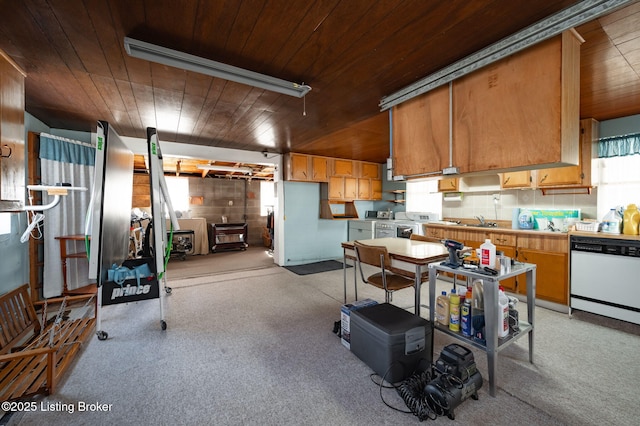 kitchen with tasteful backsplash, range, wood ceiling, white dishwasher, and light countertops