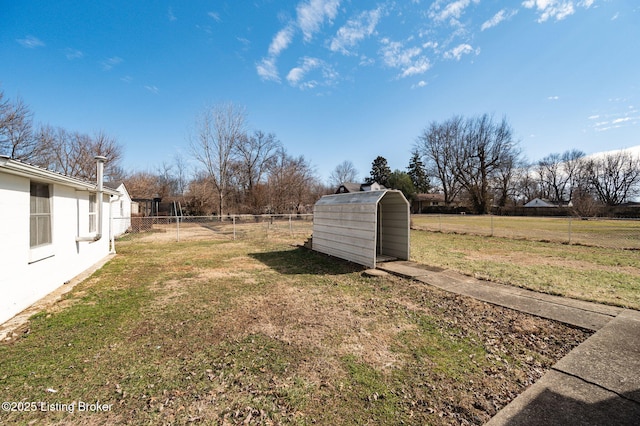 view of yard with a storage shed, fence, and an outdoor structure