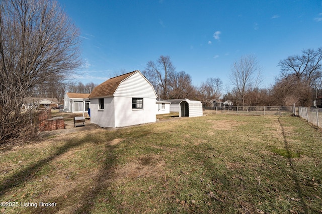 view of yard with an outbuilding and fence