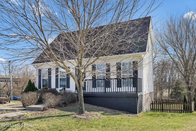 cape cod home with a shingled roof, fence, a gambrel roof, and a front yard