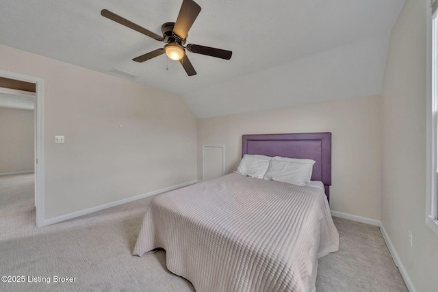 bedroom featuring lofted ceiling, carpet, visible vents, and baseboards