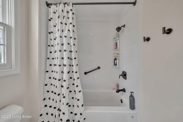 bathroom with shower / tub combo and toilet