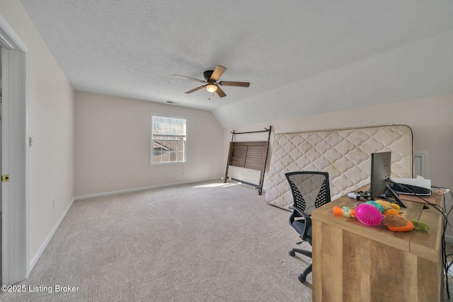 carpeted home office featuring a textured ceiling, lofted ceiling, a ceiling fan, and baseboards