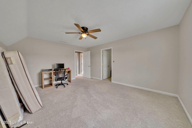 unfurnished office with carpet flooring, a ceiling fan, and baseboards