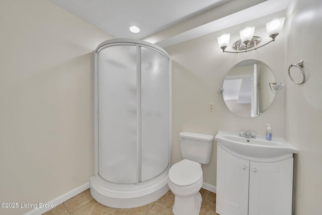 bathroom featuring baseboards, toilet, tile patterned floors, vanity, and a shower stall