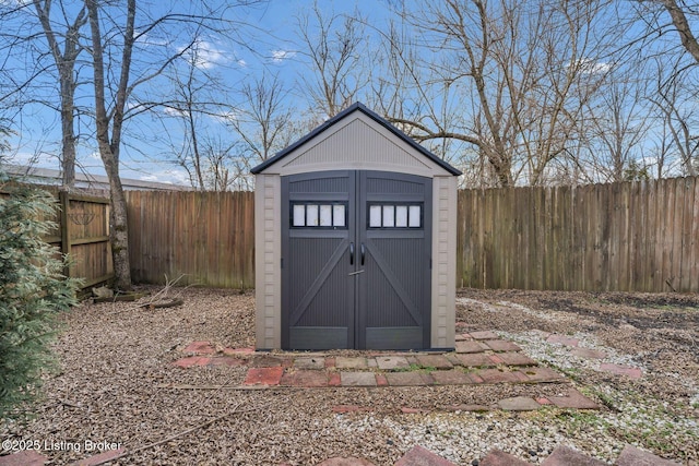 view of shed with a fenced backyard