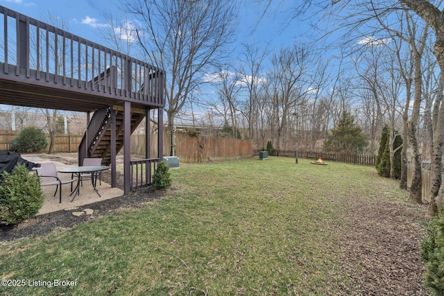 view of yard featuring a fenced backyard, stairs, a deck, and a patio