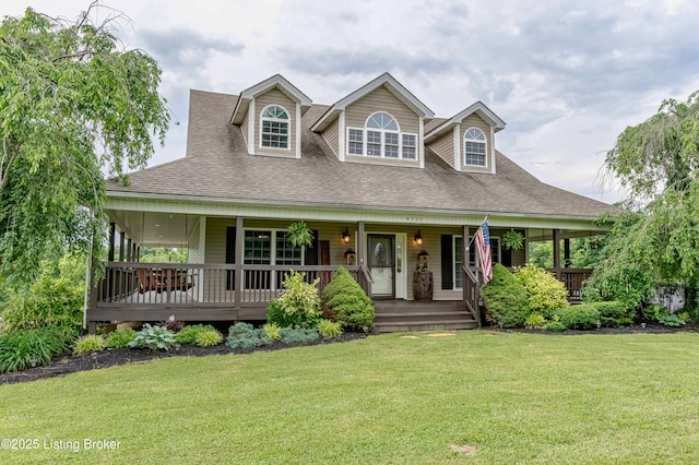 country-style home featuring a shingled roof, a front yard, and covered porch