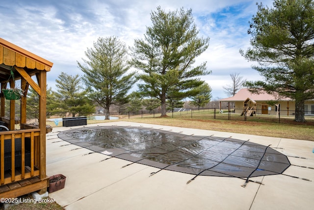 view of swimming pool featuring a lawn, a patio area, fence, and a fenced in pool