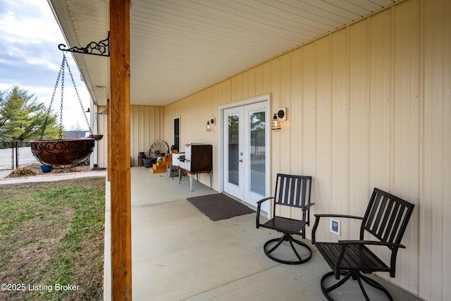 view of patio / terrace featuring french doors and fence