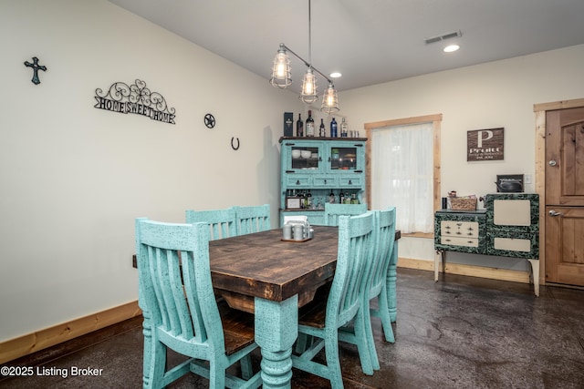 dining area featuring concrete flooring, recessed lighting, visible vents, and baseboards