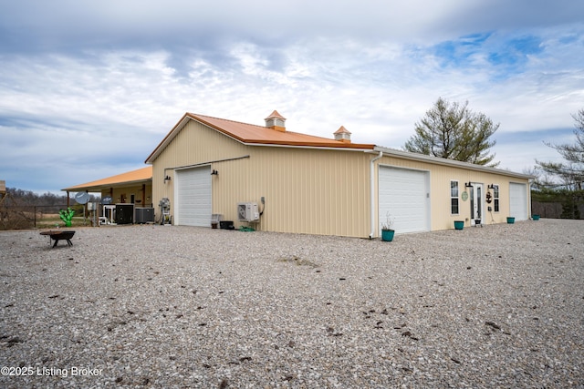 exterior space with an outbuilding, a detached garage, and central AC unit