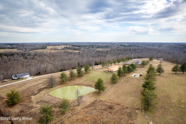 birds eye view of property featuring a wooded view