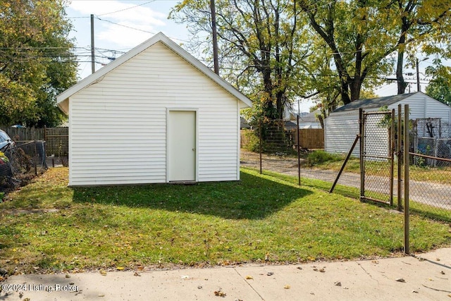 view of outdoor structure with an outbuilding and fence