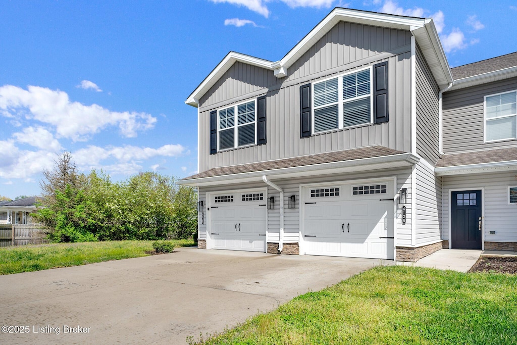 view of front of home featuring a garage, roof with shingles, board and batten siding, and concrete driveway