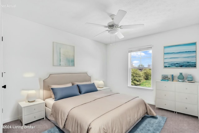 bedroom with light carpet, ceiling fan, and baseboards