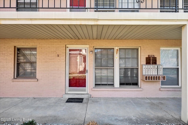 doorway to property with brick siding