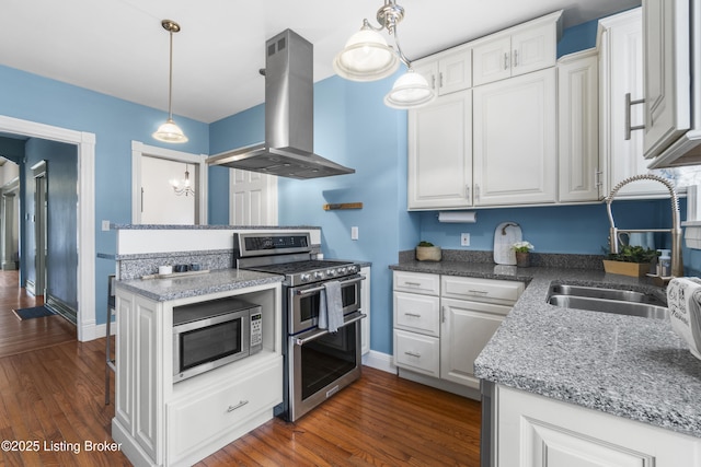 kitchen with appliances with stainless steel finishes, white cabinetry, and island range hood