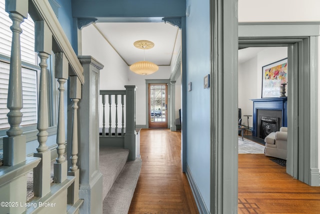 hall with stairs, baseboards, and dark wood finished floors