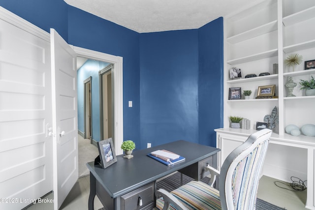 office area with a textured ceiling