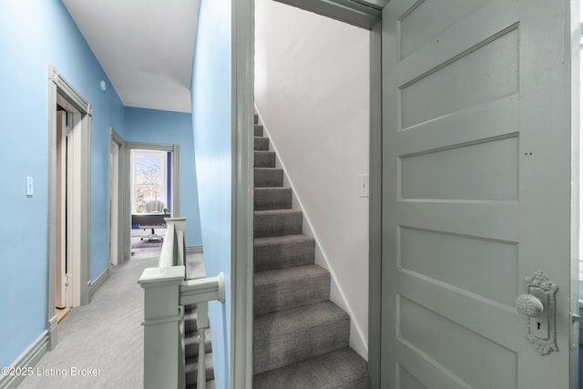 stairs with carpet floors and baseboards