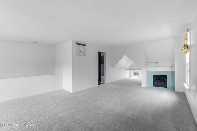 unfurnished living room featuring light carpet and a fireplace