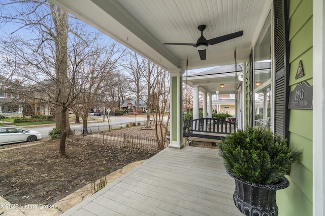 wooden terrace featuring a porch and a ceiling fan